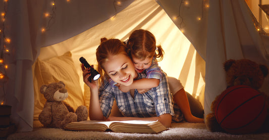 A mother with his child in a pillow fort 