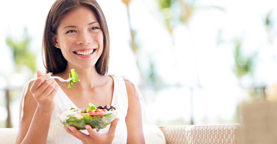 Woman eating a salad.