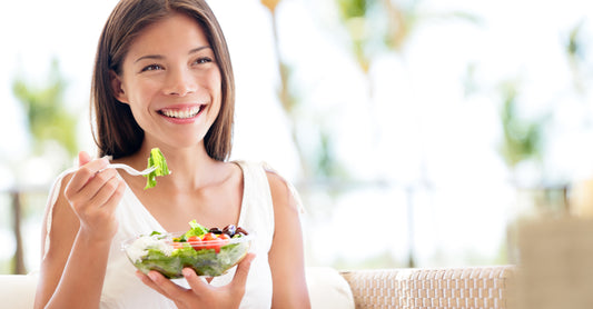 Woman eating a salad.