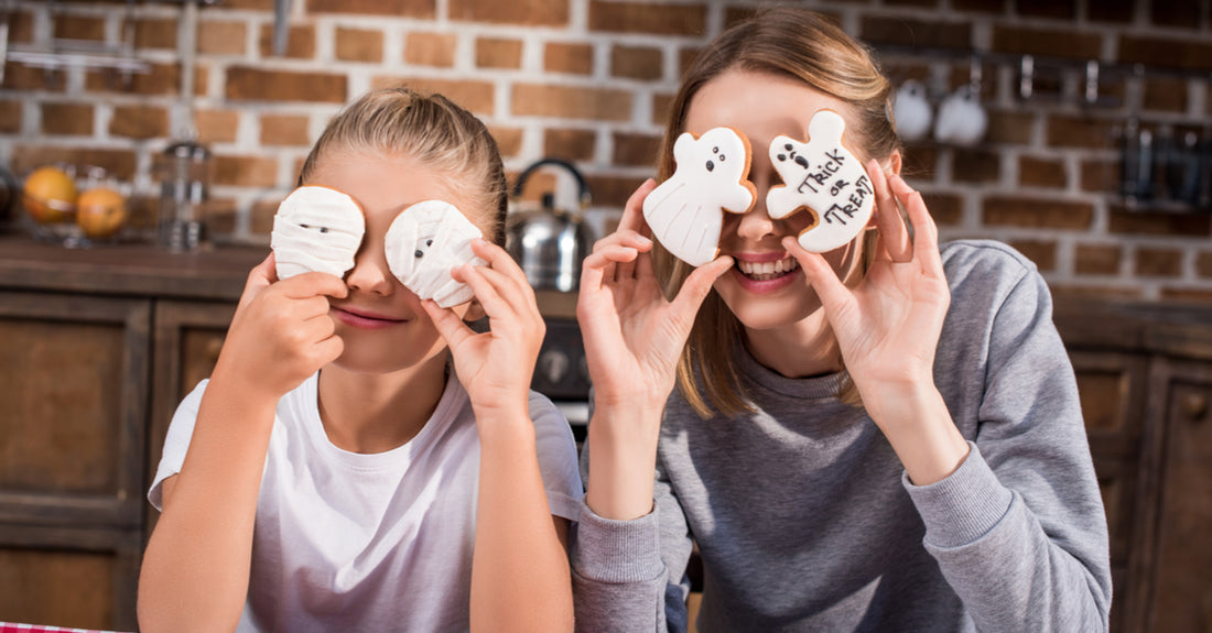 Mom and daughter playing with halloween treats